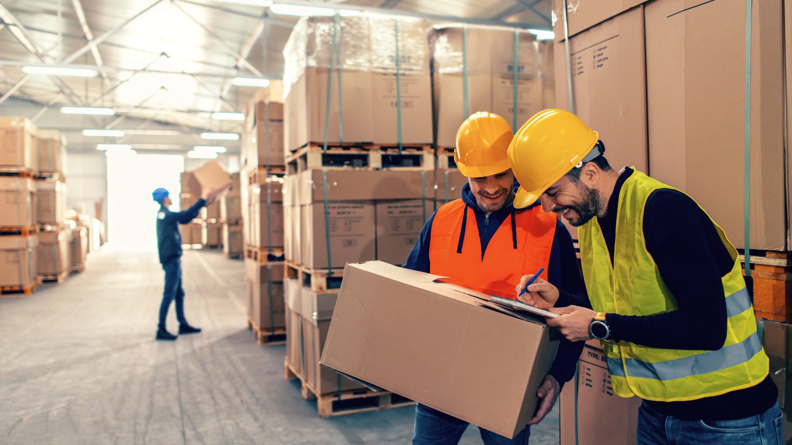 Facility manager in warehouse meeting with building services contractor