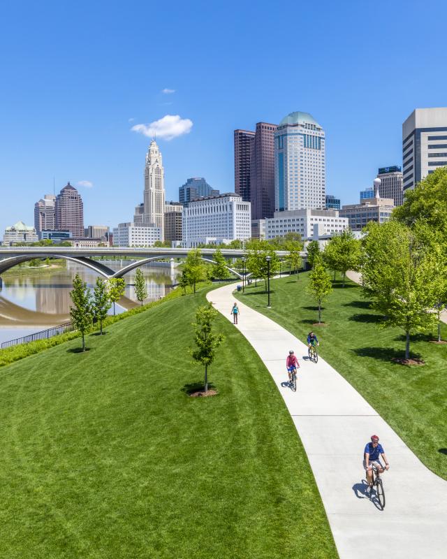 Columbus bikers riding on bike path with skyline in background Columbus bikers riding on bike path with skyline in background